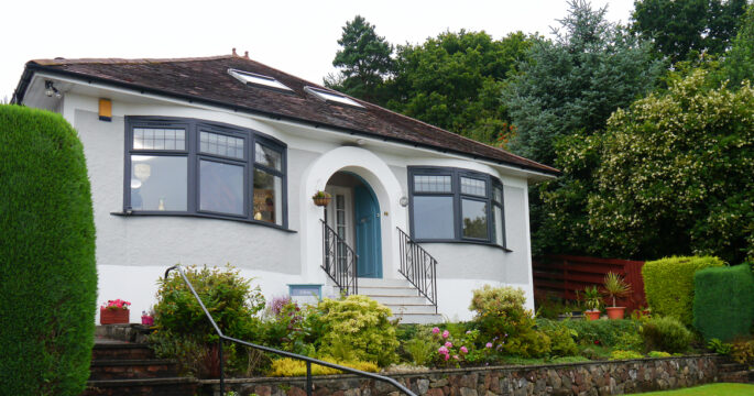 Exterior of 1930s bungalow with anthracite grey Lorimer casement windows