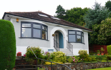 Exterior of 1930s bungalow with anthracite grey Lorimer casement windows