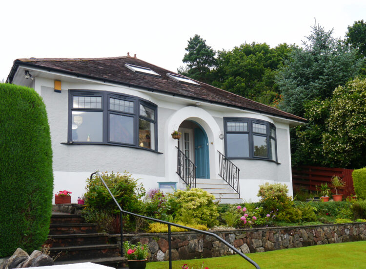 Exterior of 1930s bungalow with anthracite grey Lorimer casement windows