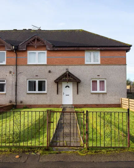 External shot of house in Clydebank home with new white reversible windows and Georgian PVC door by CR Smith.