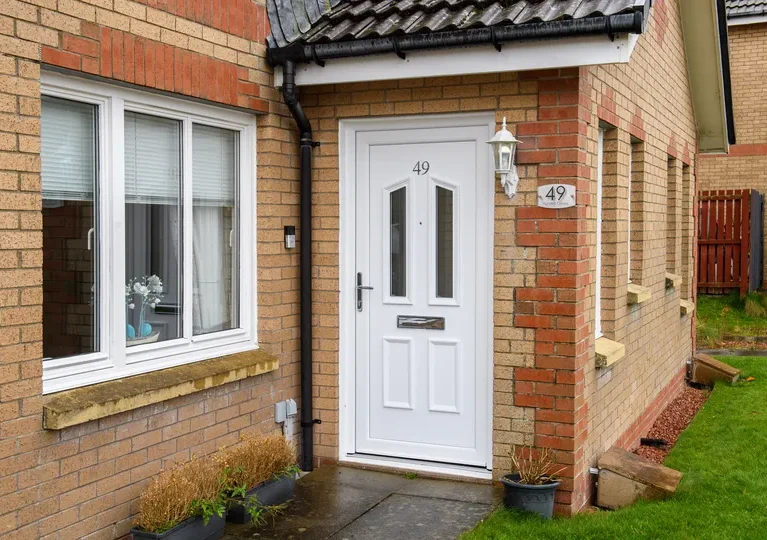 White PVCu back door by CR Smith for Wellhouse Housing Association