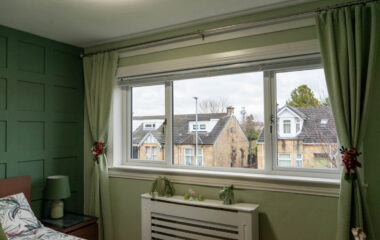 Interior view of white Lorimer casement windows overlooking the garden in Wishaw, Glasgow.