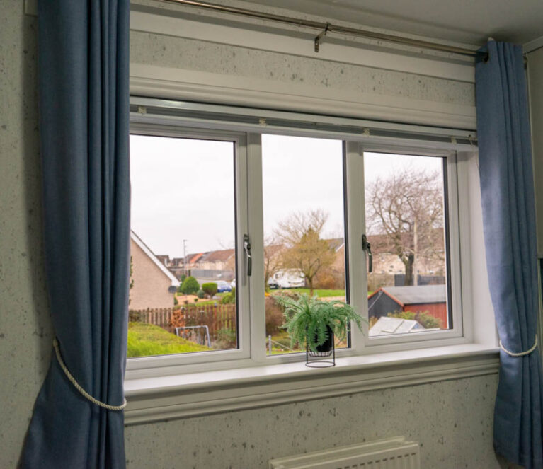 Interior view of Lorimer casement windows installed in a bedroom in a home in Wishaw, Glasgow