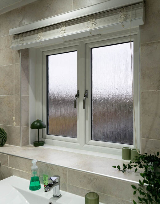 Side angle interior view of white casement windows installed in a bathroom in a home in Wishaw, Glasgow.