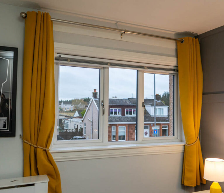 Interior view of white Lorimer Casement windows with white engineered sill and surrounds overlooking the garden in Wishaw, Glasgow.