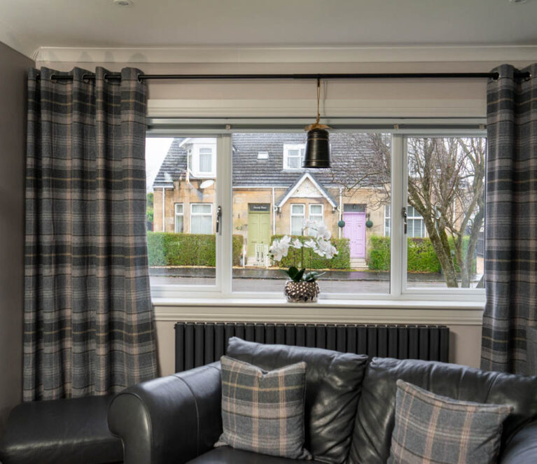 Interior view of white Lorimer casement windows installed in a living room in a home in Wishaw, Glasgow.
