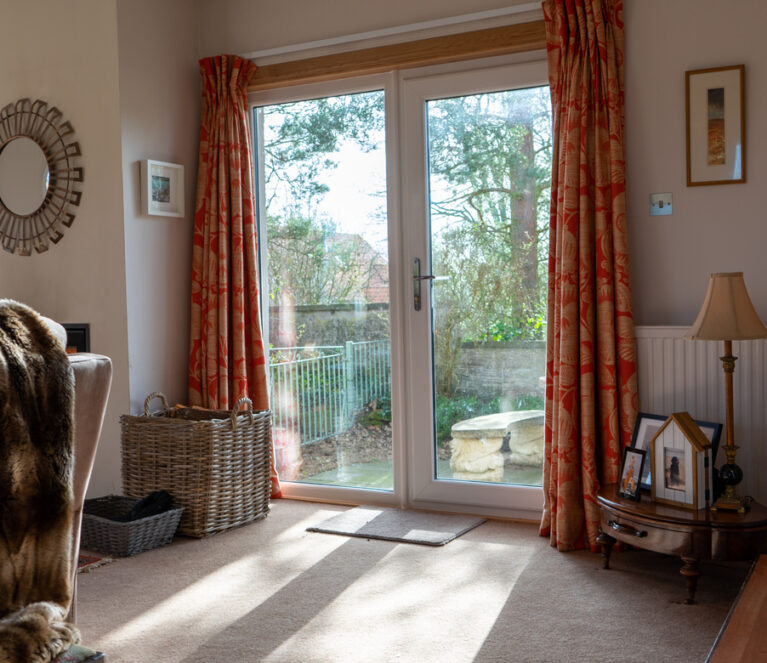 Interior view of white Lorimer uPVC Door overlooking the garden in Cupar.