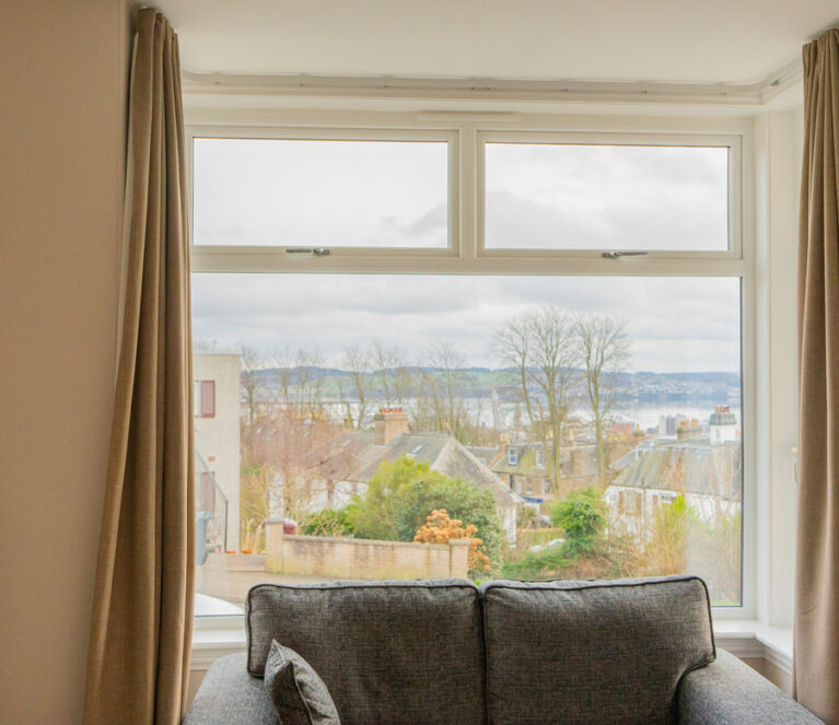 Interior view of white Lorimer casement windows overlooking the River Tay in Dundee