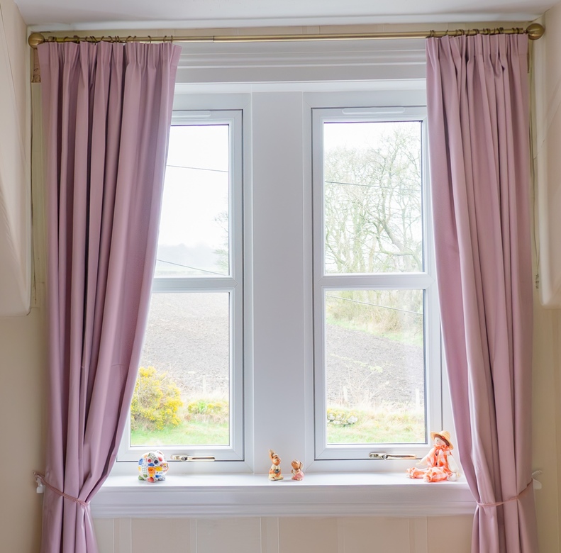 Interior view of white Lorimer casement windows overlooking the garden in Fife