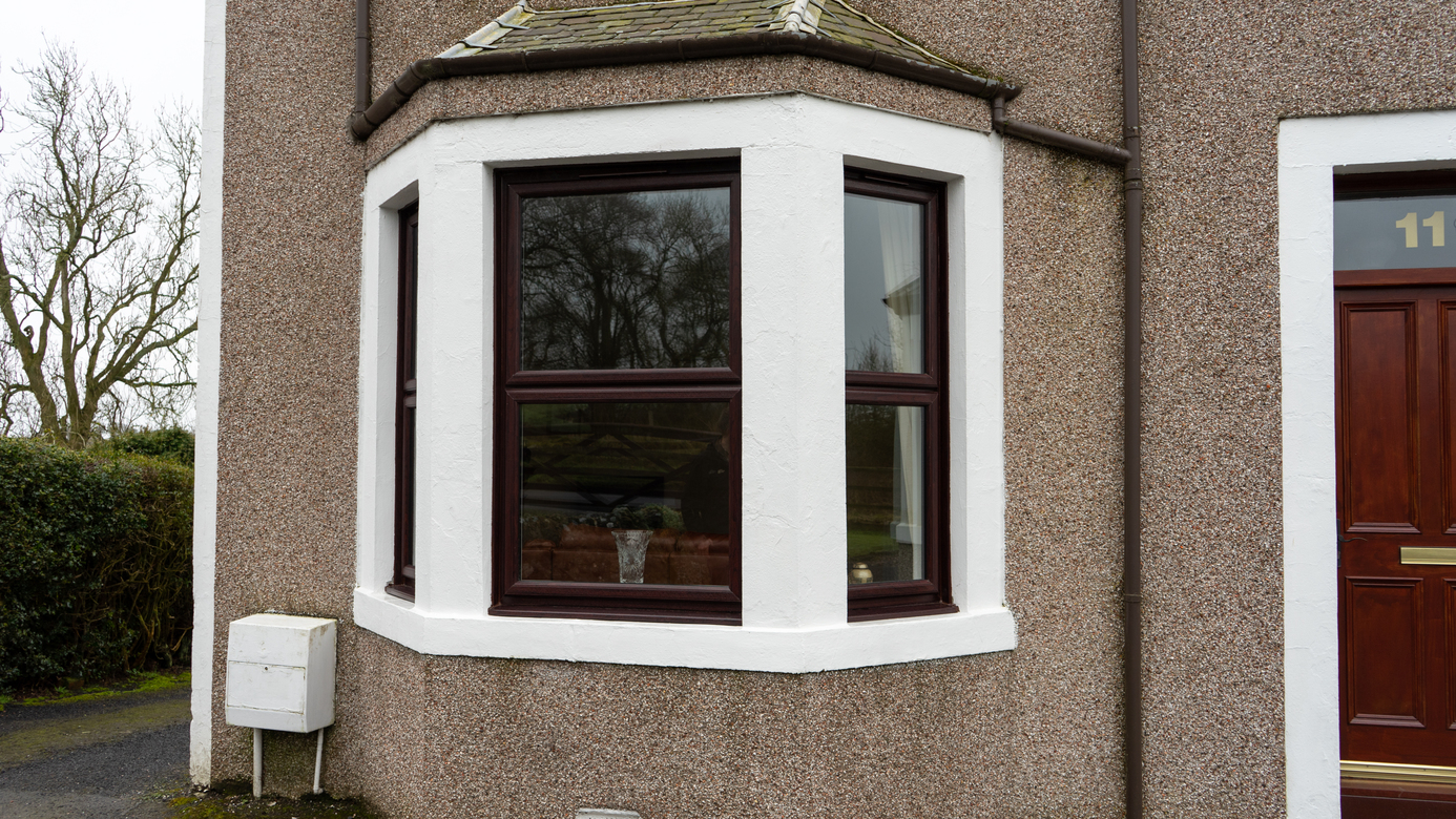 Exterior view of rosewood Lorimer casement windows installed in Fife.