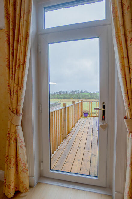 Interior view of a white Lorimer uPVC door overlooking the garden in Fife.