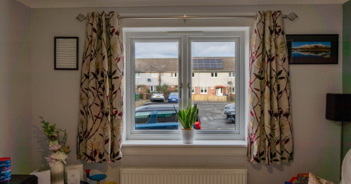 Internal shot of white casement windows in a living room.