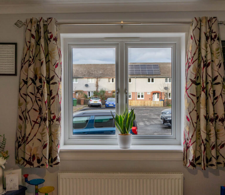 Internal shot of white casement windows in a living room.