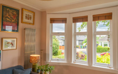 White casement windows configured to mimic sliding sash windows with white timber sills and surrounds.
