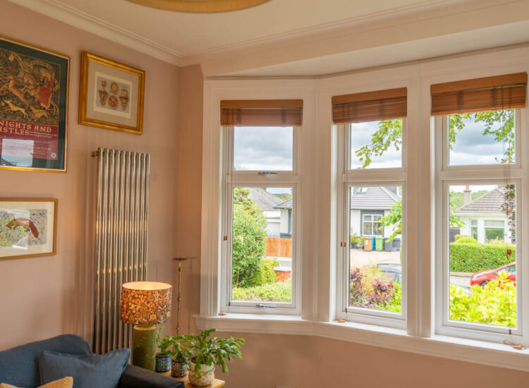 White casement windows configured to mimic sliding sash windows with white timber sills and surrounds.