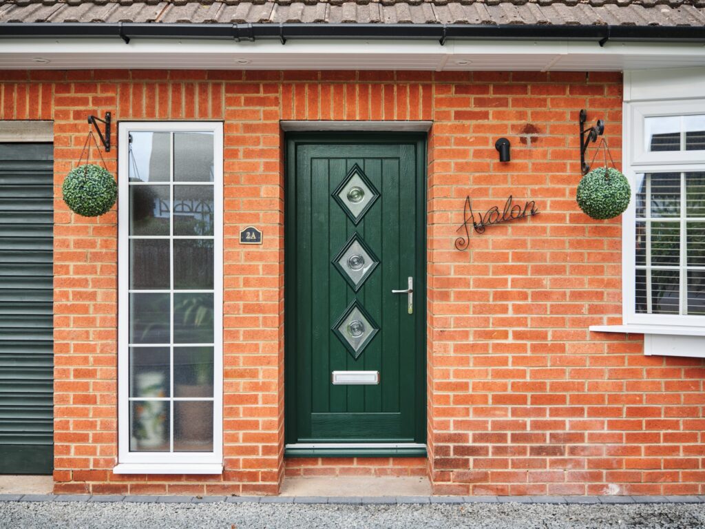 Exterior shot of a TimberLuxe front doo in Racing Green, complete with a graphite lever.
