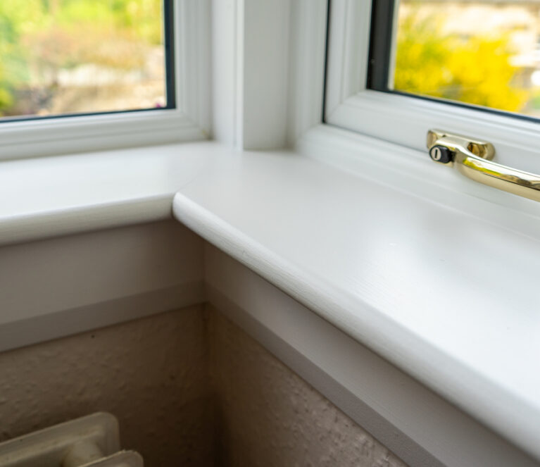 Internal view of a white sill of a lorimer casement window in Falkland home.