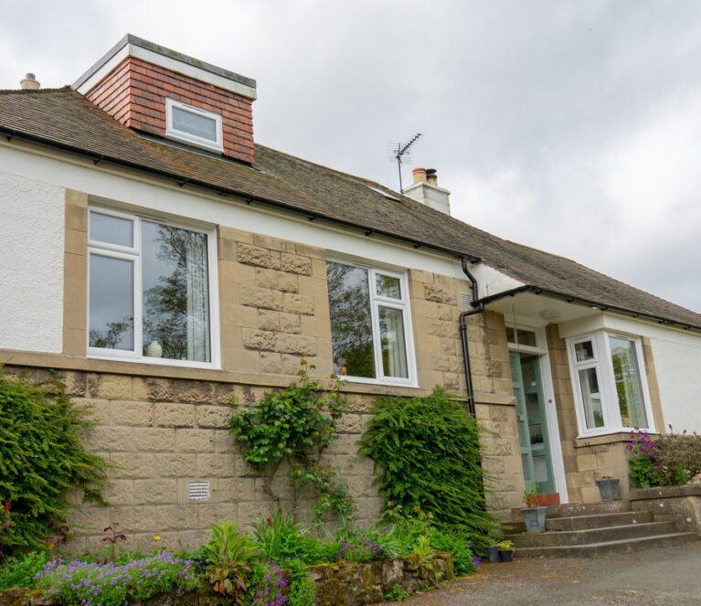 External full house view of Lorimer casement windows in Falkland home.